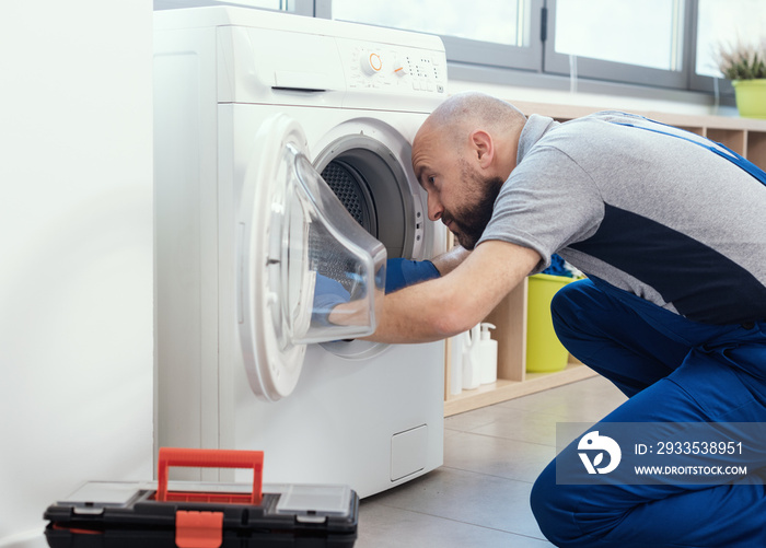 Professional repairman fixing a washer