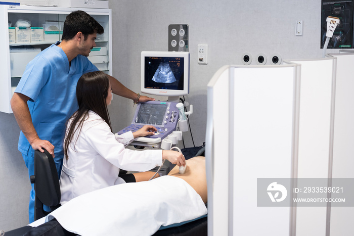 Doctor examining patient with ultrasound scan