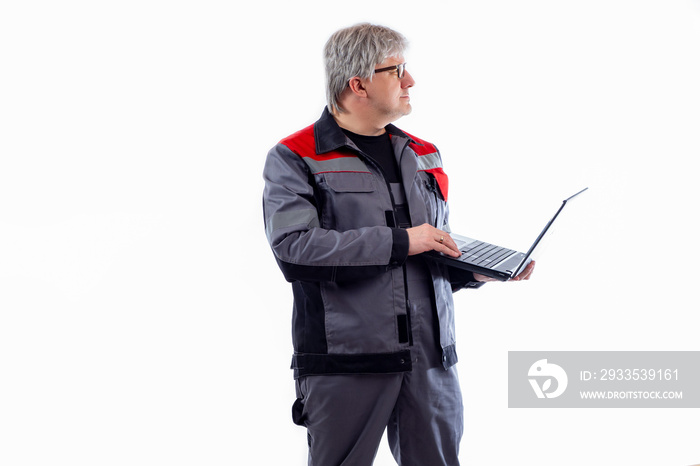 Adult computer technician. Gray-haired computer technician with laptop. She works as engineer or system administrator. Computer engineer in gray uniform. System administrator on white background