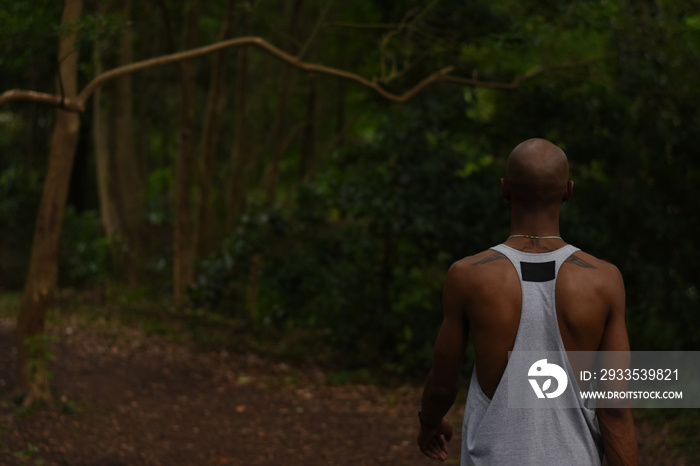 USA, Louisiana, Rear view of man in tank top standing in forest