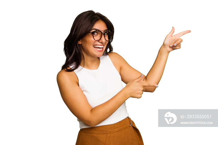 Young Indian woman isolated on green chroma background excited pointing with forefingers away.