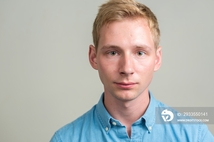 Portrait of young handsome businessman with blond hair