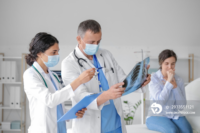 Doctors studying x-ray image of lungs in clinic