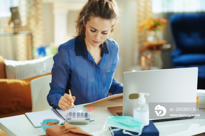 trendy woman at modern home in sunny day working