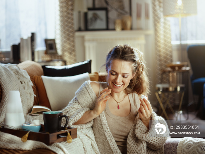 woman eating pastries at modern home in sunny autumn day