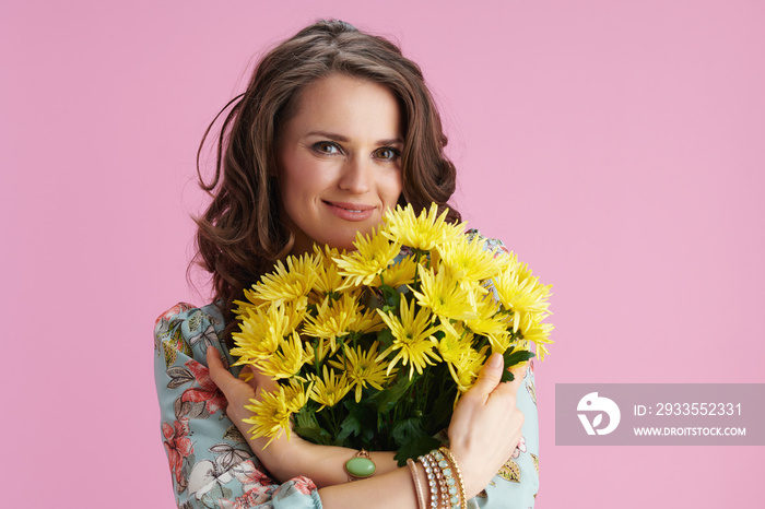 happy young woman with long wavy brunette hair on pink