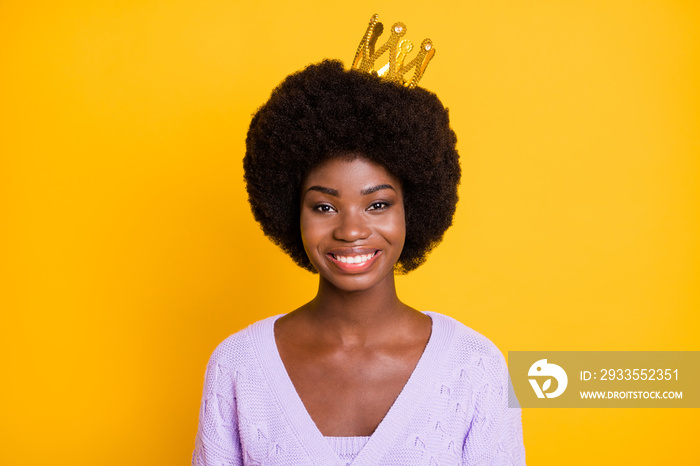 Portrait of charming dark skin lady gold crown on head beaming smile look camera isolated on yellow color background