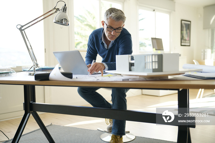 Architect in office working on construction project