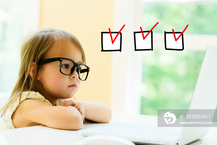 Checklist with little girl using her laptop