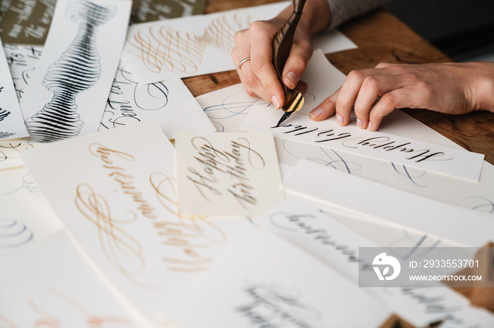 Calligrapher girl writing while working at table indoors