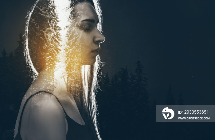 Double exposure of meditating woman and forest on dark background