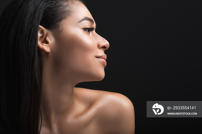 Close up profile of smiling lady having her locks down. Copy space in right side. Isolated on black background