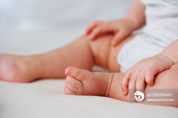 Shot of tiny baby’s foot and hand