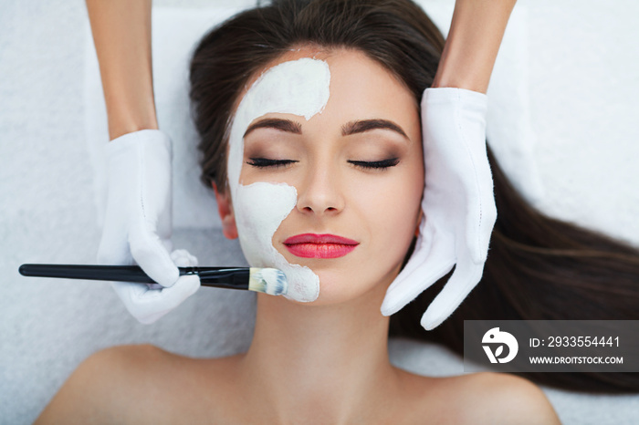 Facial Skin Care. Beautiful Woman Getting Cosmetic Mask In Salon