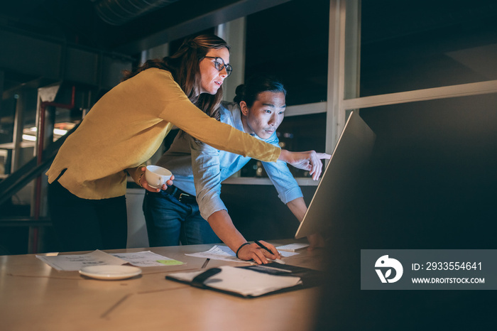 Business colleagues discussing business work late in office