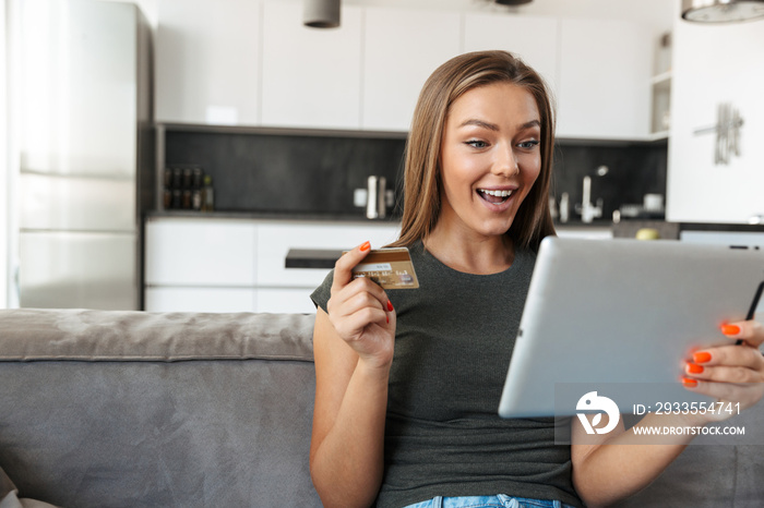 Smiling young woman sitting on a couh at home