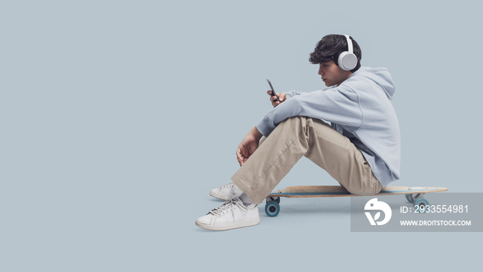 Skater sitting and using a smartphone