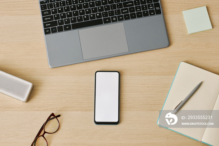 Minimal top view smartphone with white screen mockup at desk workplace