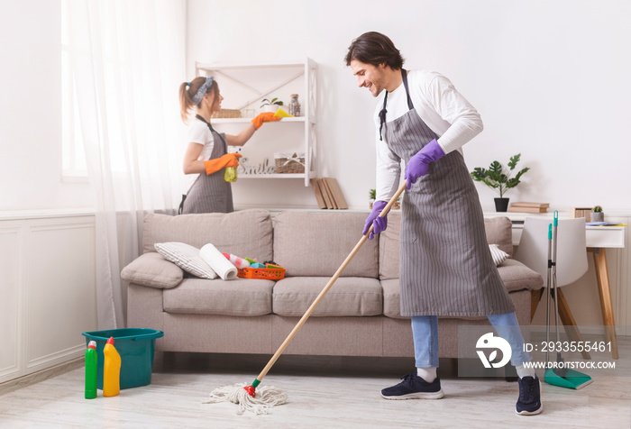 Residential Cleaning Services. Couple Of Skilled Housekeepers Tidying Up Apartment