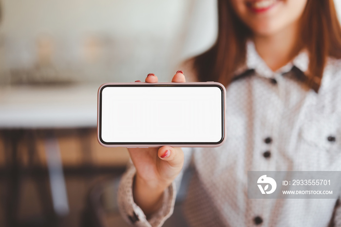 Woman hands showing mockup white screen mobile phone.