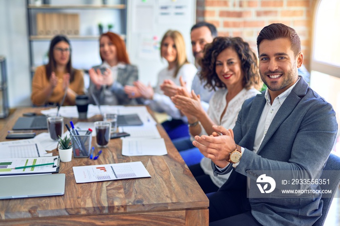 Group of business workers smiling happy and confident. Working together with smile on face looking at the camera applauding at the office