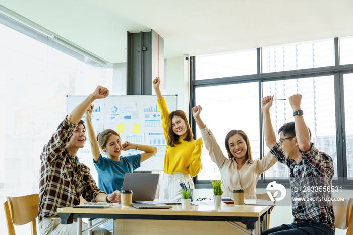 Group of Asian team creative business people hand raise up partnership teamwork concept, victory concept.