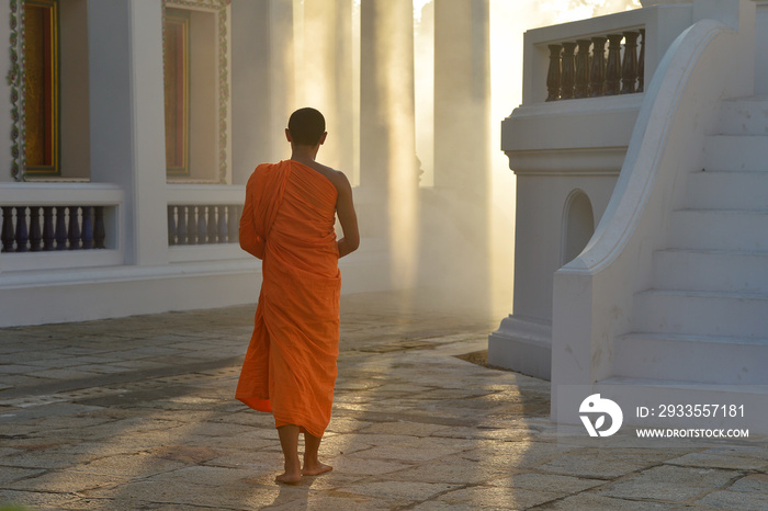 Buddhist monks are walking in temple on during sunset,Thailand