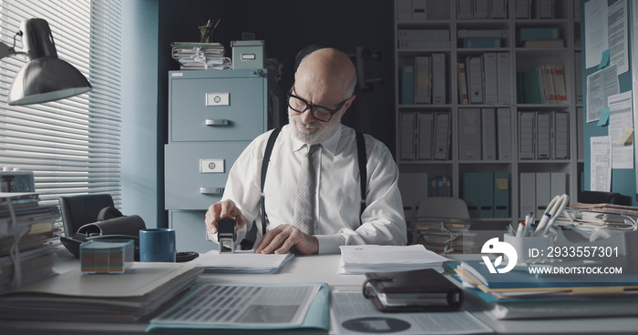 Businessman stamping documents in the office