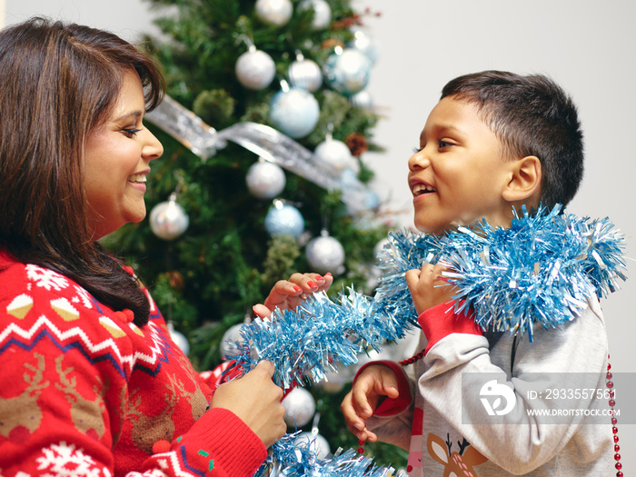 Mother and son playing with Christmas decorations