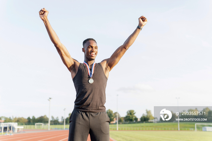 Portrait of athlete celebrating with medal