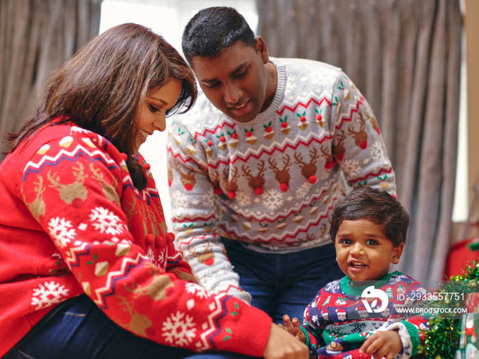 Parents and son playing with Christmas decorations