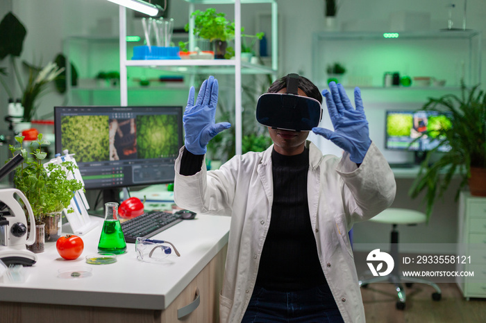 African scientist biologist conducting research using virtual reality doing hand gesture for agronomy looking at sample. Medical team working in pharmaceutical laboratory analyzing dna test.