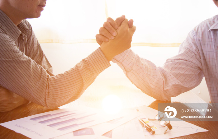 Business, two businessmen arm wrestling in a competitive busines