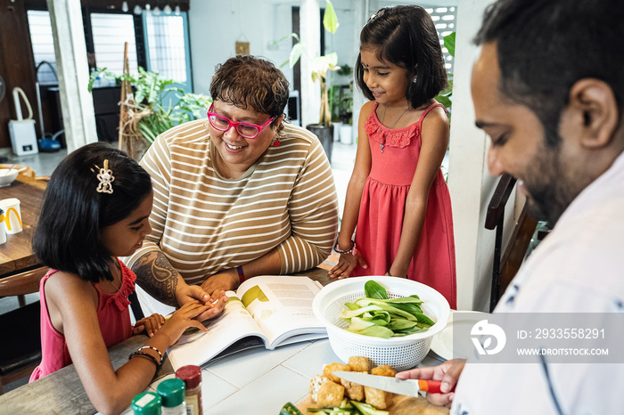 Kids helping their parent cook a healthy meal for the family dinner at home