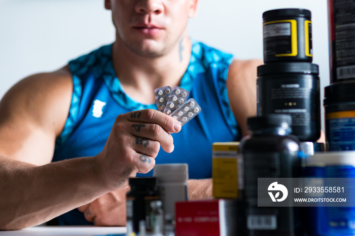 Close up of drugs in hands of a professional bodybuilder