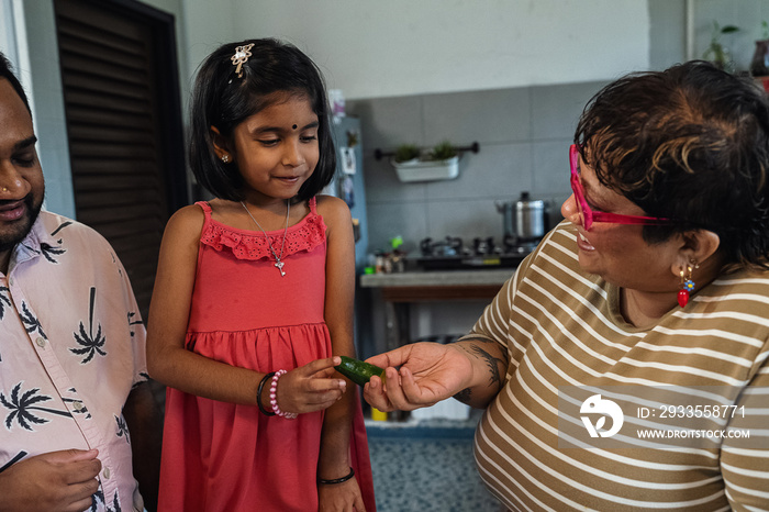 Kids helping their parent cook a healthy meal for the family dinner at home