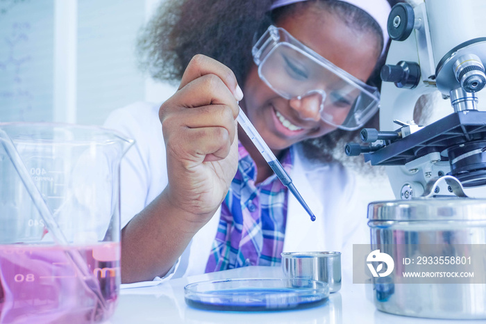 African kid girl scientist testing liquid chemical in laboratory,reserch and development concept.