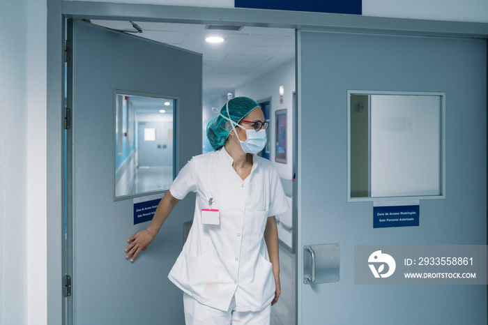 Portrait of unrecognizable young woman doctor looking at camera