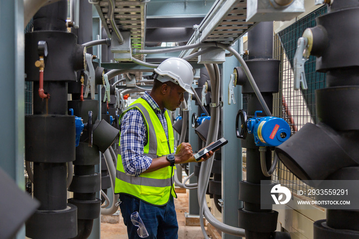 Engineer under industrial inspection Large water heaters are used in high-rise condominiums.