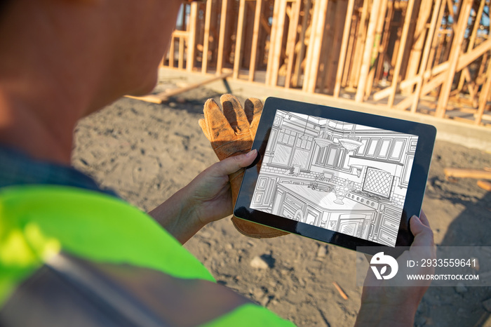 Female Construction Worker Reviewing Kitchen Drawing on Computer Pad at Construction Site