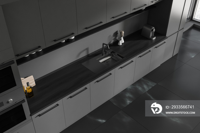 Top view of black kitchen interior with sink and kitchenware on deck