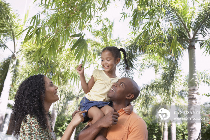 Happy parents with daughter enjoying together in park