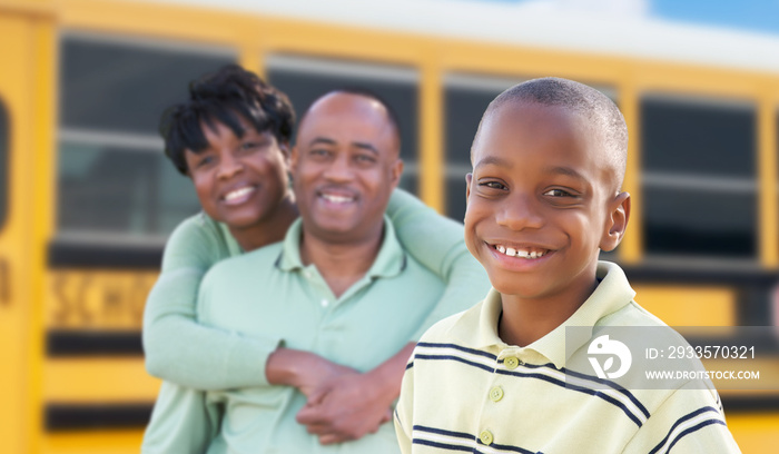 Proud African American Parents and Young Boy Near School Bus