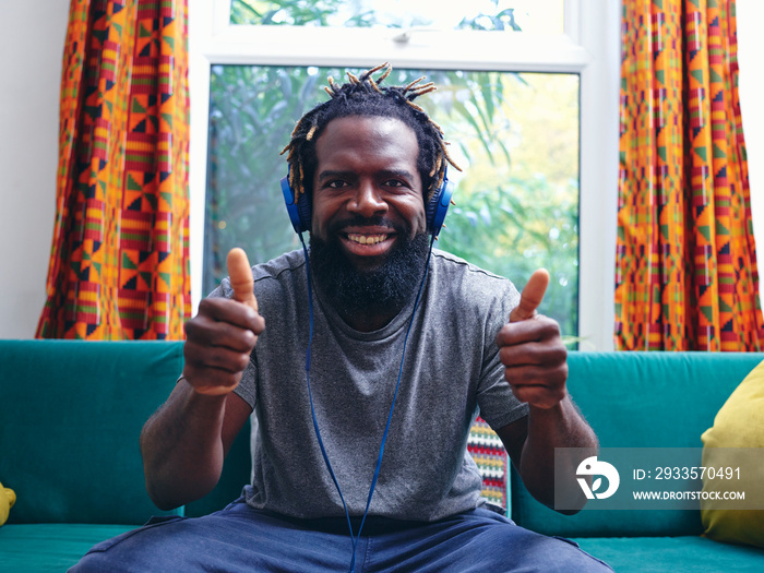 Portrait of man listening to music on headphones