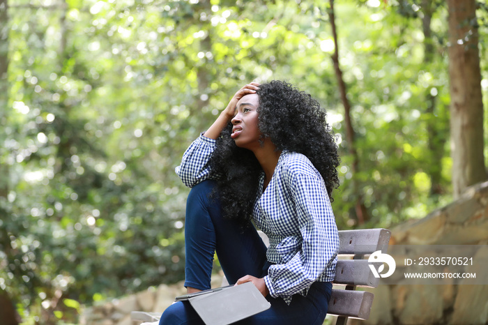 Sorrowful black woman with electronic reader