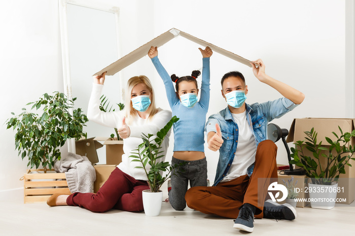 family in protective masks quarantined. Normal life with coronavirus. Lifestyle COVID-19. Quarantine virus protection sterility home together heart symbol