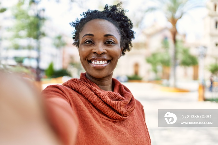 Young african american girl smiling happy make selfie by the smartphone at the city.