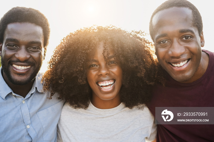 Young african people smiling on camera outdoor in the city - Focus on center girl face