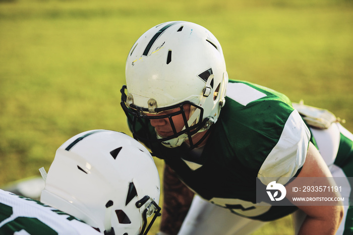 Two football players lining up for defensive drills during pract