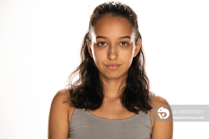 portrait of beautiful young latin woman without makeup on white background